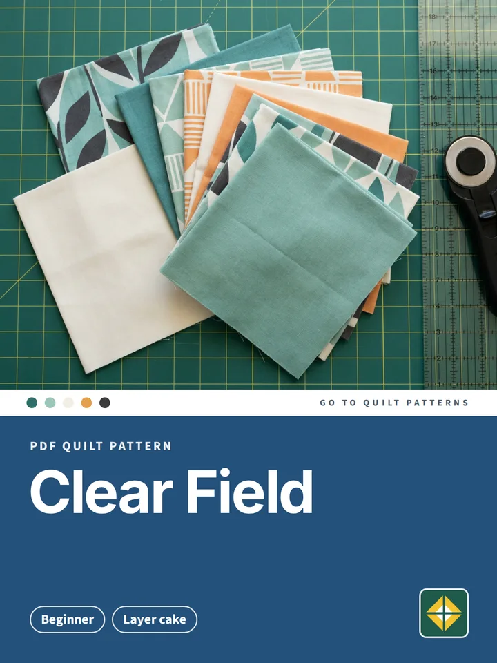 Clear Field Quilt pattern cover: photo of layer cake on a cutting mat